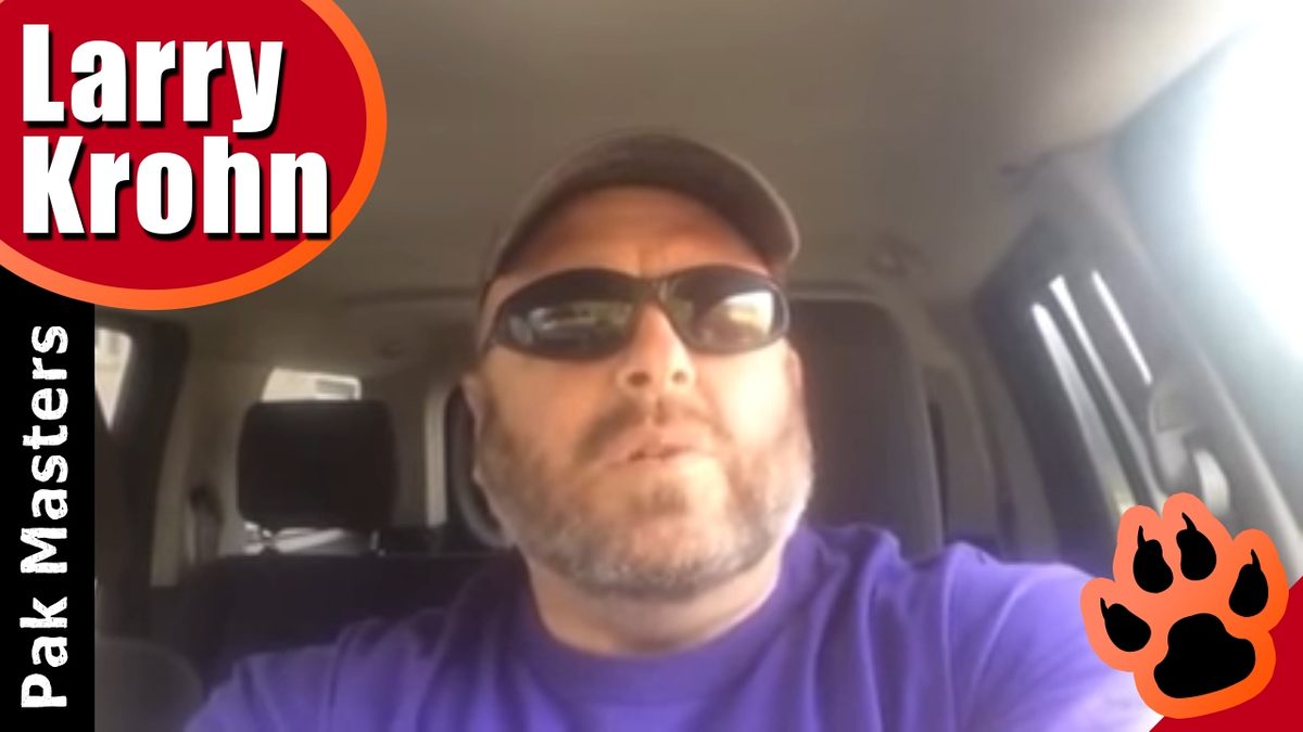 Larry Krohn talking to the camera from his truck in a Pak Masters video about training aggressive dogs
